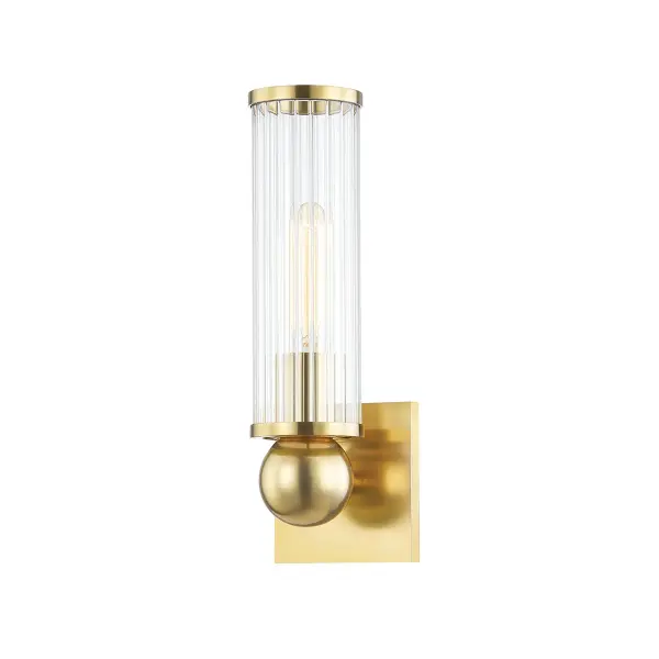 The Malone wall sconce delivers refined lighting in a compact 4.5-inch profile. Its aged brass finish and clear optic glass create warm, sophisticated ambiance perfect for bathrooms, hallways, and intimate spaces.