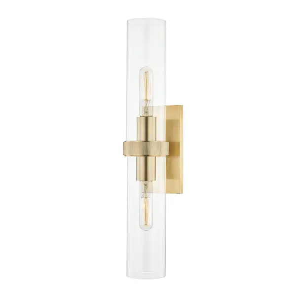 The Briggs wall sconce combines classic styling with modern functionality. Its elongated vertical profile and aged brass finish bring warmth and sophistication to any space, while clear glass shades provide ample illumination.