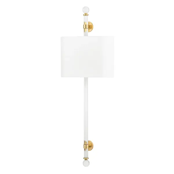 The Wertham wall sconce makes a bold vertical statement at 36 inches tall, perfect for flanking mirrors or creating dramatic hallway lighting. The aged brass finish and white linen shades deliver sophisticated warmth.