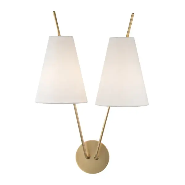 The Campagna wall sconce combines aged brass metalwork with white linen shades for a sophisticated, versatile look. Its 22-inch height and dual-light design make it ideal for flanking mirrors, artwork, or architectural features.