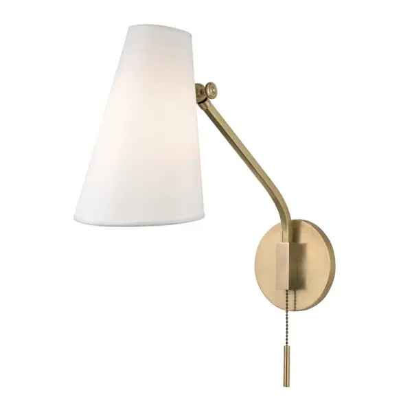 The Patten wall sconce combines mid-century design with practical functionality. Its swiveling conical shade allows you to direct light exactly where needed, while clean lines and aged brass finish add timeless appeal to any space.