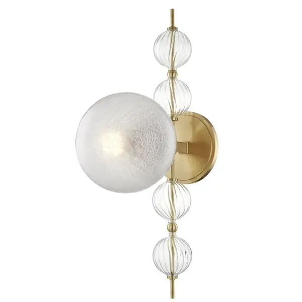 Calypso delivers maximalist flair with its distinctive fluted-spiral glass orbs and crackle-glass diffusers. The aged brass finish adds warmth while the sculptural geometry creates visual interest. Best suited for spaces that can handle its bold personality.
