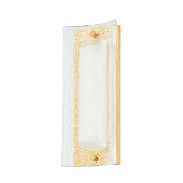 The Philmont wall sconce combines translucent Piastra glass with aged brass for a sophisticated, multi-layered aesthetic. Its integrated LED provides energy-efficient, warm illumination with excellent color rendering, making it ideal for intimate spaces.