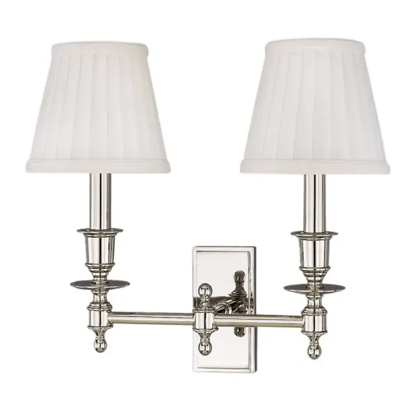 The Ludlow wall sconce combines timeless design with practical lighting. Its aged brass finish and faux silk shades create a warm, sophisticated ambiance perfect for bathrooms and bedrooms.