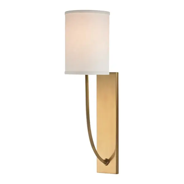 The Colton wall sconce brings serene sophistication with its curved arms and clean lines. The aged brass finish adds warmth while the drum shade provides soft, diffused light perfect for intimate spaces.