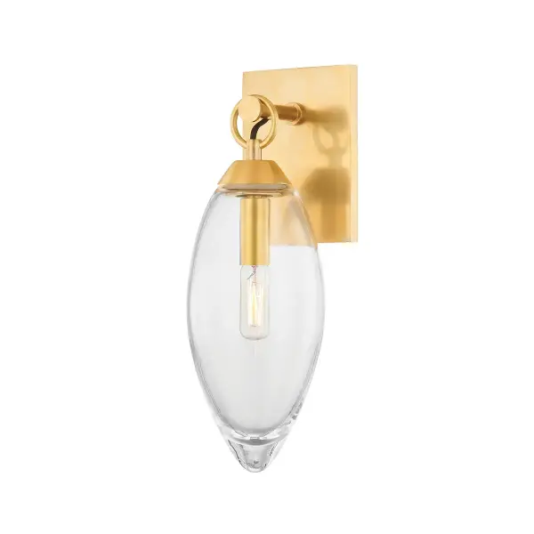 The Nantucket wall sconce showcases artisanal blown glass that pools light beautifully within a simple metal ring. Each piece is unique due to hand-blown glass variations, offering luxe coastal-transitional style perfect for intimate spaces.