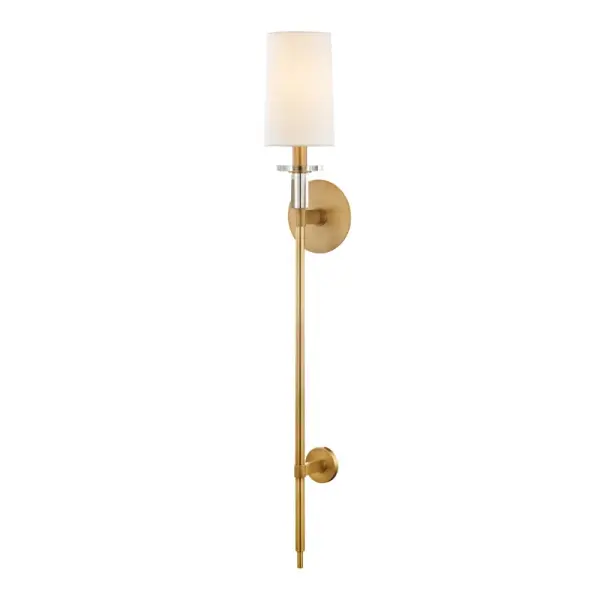 The Amherst wall sconce brings sophisticated vertical drama to any space with its impressive 36.5-inch height and warm aged brass finish. The faux silk shade softens the light beautifully while the slender profile works in both traditional and contemporary settings.
