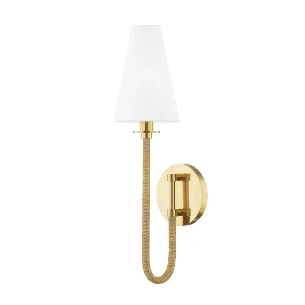 The Ripley sconce beautifully blends natural materials with refined metalwork. Its looping J-shape frame wrapped in handcrafted rattan creates visual interest, while the white linen shade provides soft, diffused light perfect for intimate spaces.