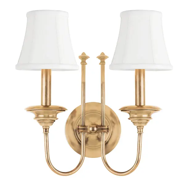 The Yorktown wall sconce brings heirloom-quality craftsmanship to traditional interiors. Its Dutch-inspired design features a richly proportioned metal basin, classic swooping arms, and elegantly trimmed bell shades that create sophisticated ambient lighting.