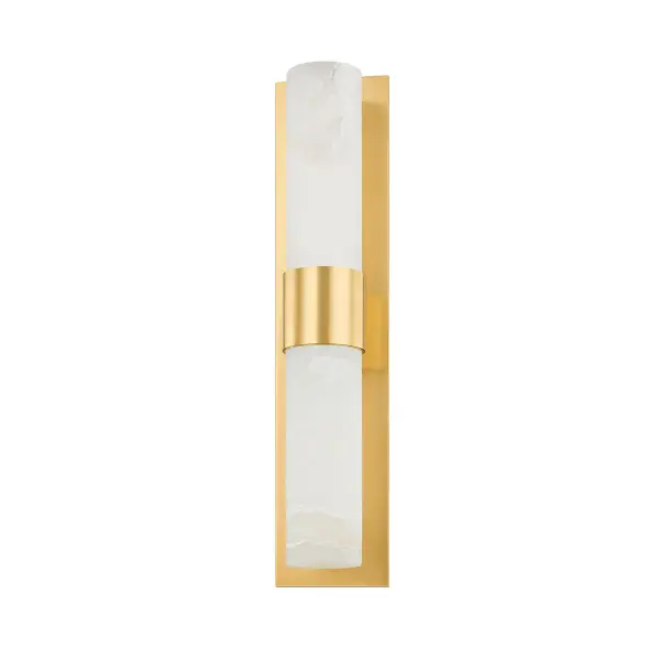 The Stowe sconce beautifully bridges traditional and modern design with its cylindrical alabaster shade wrapped in aged brass. The natural stone creates a warm, diffused glow perfect for intimate spaces, while the clean lines keep it contemporary.