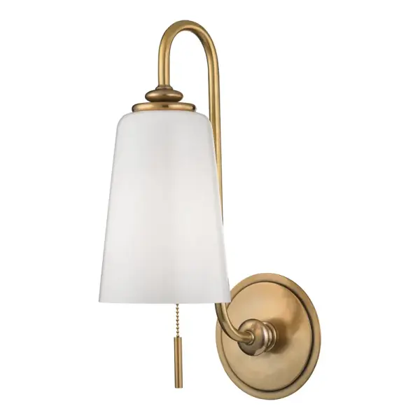 The Glover wall sconce combines classic aged brass finish with opal etched glass for a refined look. Its compact 5.5-inch width makes it ideal for smaller spaces while the 10-inch extension provides ample illumination.