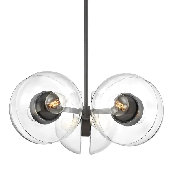 The Kert combines clear glass and black brass in a striking linear form. Its sculptural half-round glass shades and substantial 38.75-inch width make it ideal for large dining tables and kitchen islands.