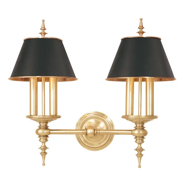 The Cheshire wall sconce makes a striking statement with its classical candlestick design and dramatic matte black shades against hand-rubbed aged brass. At 20.5 inches wide, it commands attention while providing substantial illumination.
