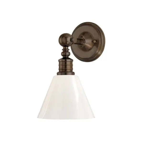 The Darien wall sconce showcases industrial design with thoughtful details like an oversized ornamental swivel, double-ringed socket holder, and decorative rivets. Its compact 8-inch width and distressed bronze finish make it versatile for various spaces.