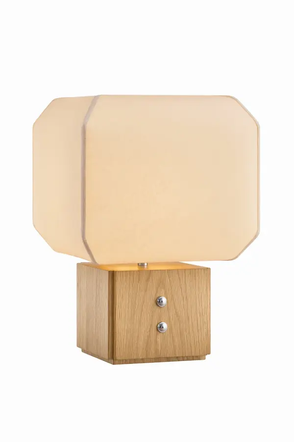 The Brice table lamp masterfully balances organic softness with refined structure. Its billowing handmade paper shade creates visual lightness while the solid white oak base grounds the design with natural warmth.