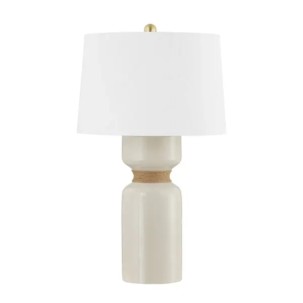 This Hudson Valley table lamp combines warm aged brass metalwork with a unique ivory crackle ceramic element, creating a sophisticated accent piece that bridges traditional and contemporary aesthetics.