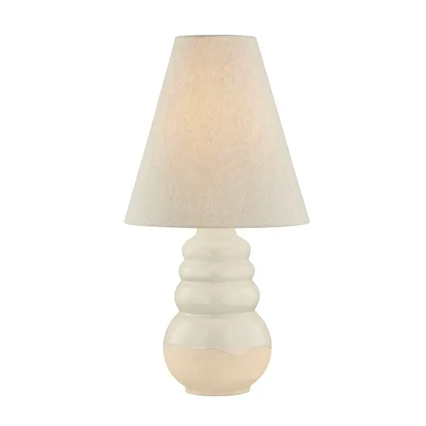 This sophisticated table lamp combines a sculptural ceramic base in elemental white with aged brass metal accents, creating a refined transitional aesthetic. The organic form and quality materials make it versatile enough for both residential and hospitality settings.