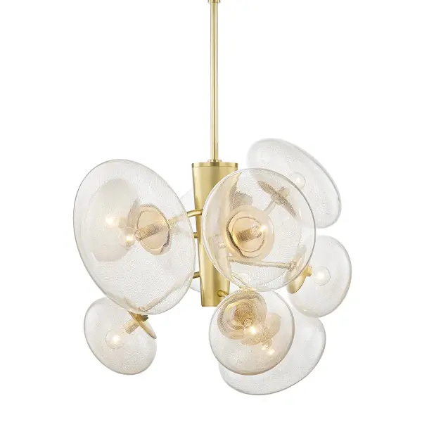 The Opera chandelier combines contemporary elegance with artisanal craftsmanship. Nine candelabra lights shine through clear glass shades accented with brass mesh, creating a warm, layered glow. The substantial 30.75-inch width makes it ideal for larger dining spaces.