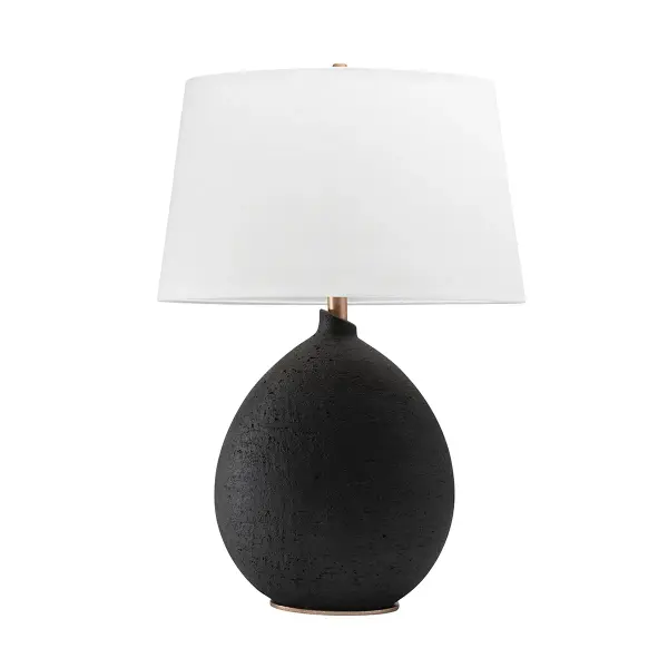 The Denali brings artisanal elegance to any space with its hand-sculpted ceramic body, gold leaf accents, and soft Belgian linen shade. Its compact 4.5" footprint makes it ideal for smaller surfaces while the 28.5" height provides substantial presence.