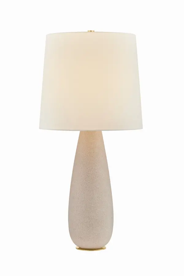 This single-light table lamp from Hudson Valley Lighting combines classic aged brass metalwork with a refined fabric shade. Its transitional design bridges traditional and contemporary aesthetics, making it versatile for various interior styles.