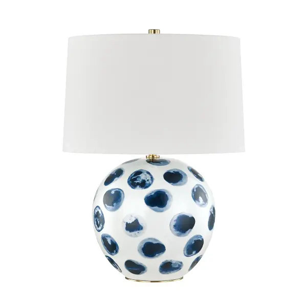 This charming table lamp features a white bisque ceramic base adorned with hand-painted blue dots, bringing a touch of whimsy and coastal charm to any space. The artisanal finish and compact size make it perfect for bedside tables, desks, or accent surfaces.