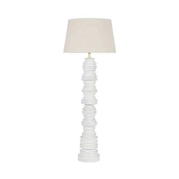 This sophisticated floor lamp combines warm aged brass metalwork with a glossy ivory ceramic shade, creating a refined lighting solution that bridges traditional and contemporary aesthetics.