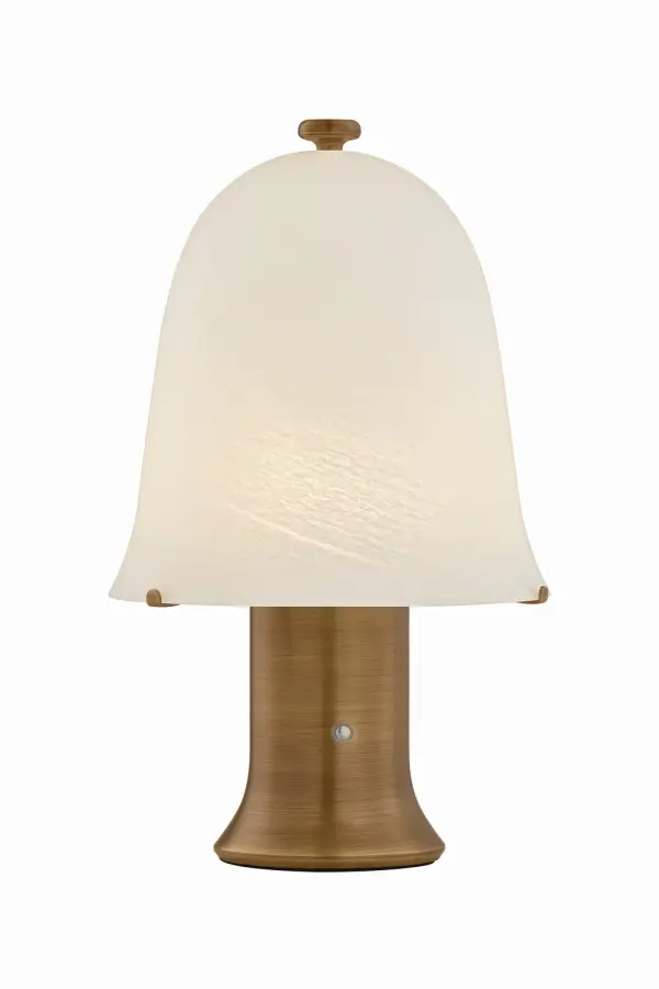 Embracing an artisanal spirit, the Kipps rechargeable table lamp is a perfect marriage of heritage craftsmanship and modern functionality. Its airy, matte cloud glass shade adds significant charm to a nightstand, side table, or bookshelf. A Patina Brass base creates a thoughtful juxtaposition against the glass of this little lamp. Collection: Kipps Designer: Hudson Valley Lighting Finish: Patina Brass Glass: Matte Cloud Width: 8.25" Height: 13.75" Weight: 3.92 lb Number of Bulbs: 1 Maximum Wattage: 3.00 W Bulb Base: Integrated Light Source: LED Light Output: 75.00 lm Color Temperature: 3000 K CRI: 90 Voltage: 100.00 V Material: Glass Country of Origin: VN Safety Listing: UL, cETL Safety Rating: Damp Switch: TOUCH DIMMER LED Manufacturer Warranty: 1 Year Limited Manufacturer Spec Sheet Instructions
