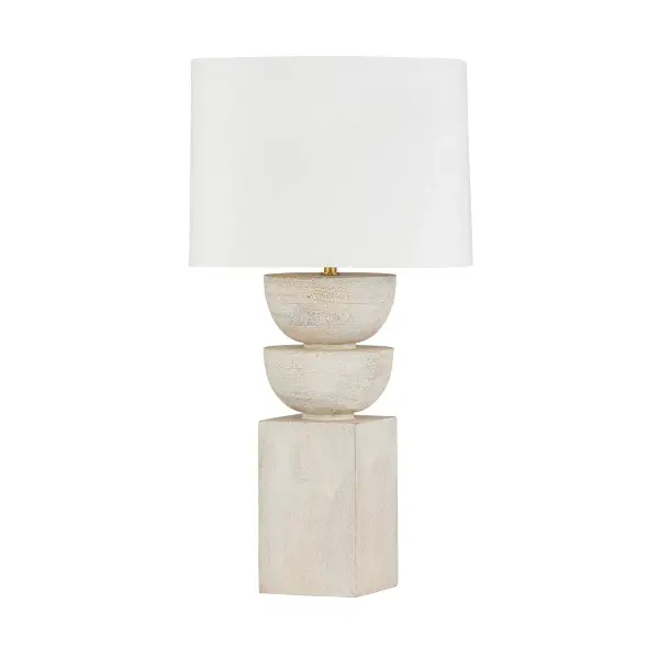 The Gardiner table lamp combines sculptural wood forms with a generous linen shade, creating a statement piece that bridges modern and organic design. Its whitewashed wood base and aged brass accents offer versatility across interior styles.