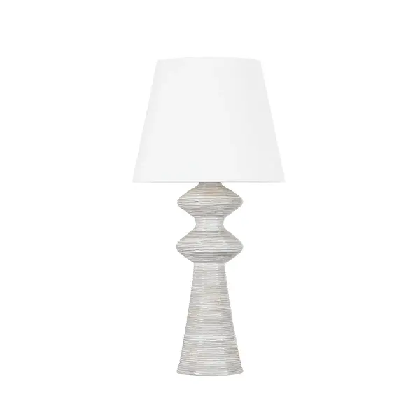 This sophisticated table lamp combines a ceramic snowbank white base with aged brass accents for a refined look that bridges traditional and contemporary styles. Perfect for adding ambient lighting to bedrooms and living spaces.