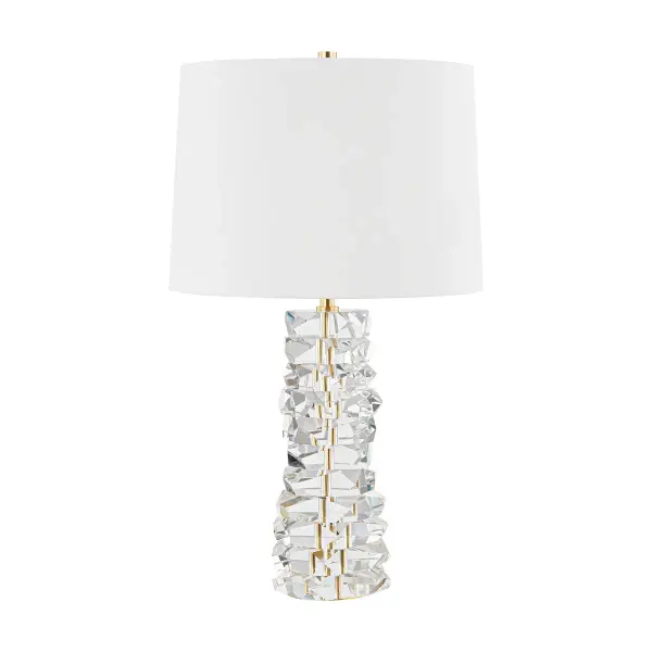 A stunning statement piece featuring stacked crystal construction that creates spectacular light refraction. The aged brass accents and white linen shade balance the opulent crystal base, making it versatile enough for both traditional and contemporary interiors.