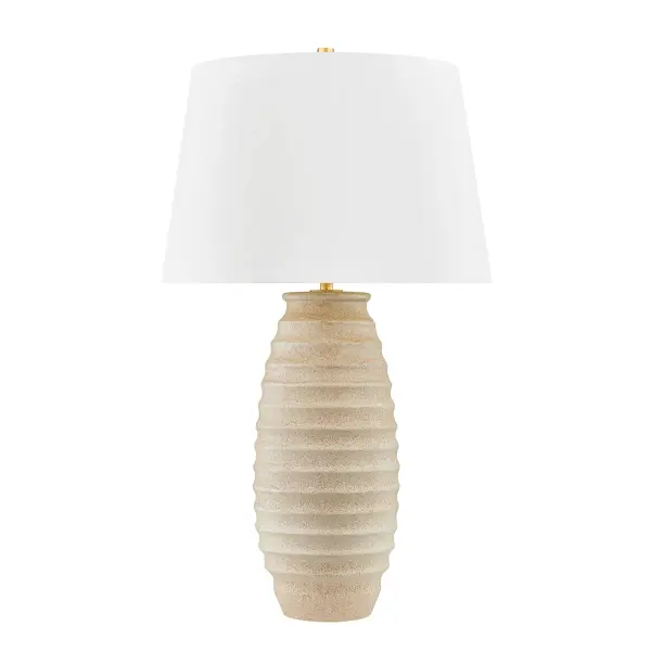 This Hudson Valley table lamp combines a textured ceramic base in warm fawn tones with aged brass accents for a refined transitional aesthetic. The organic texture and quality craftsmanship make it versatile across traditional and contemporary interiors.