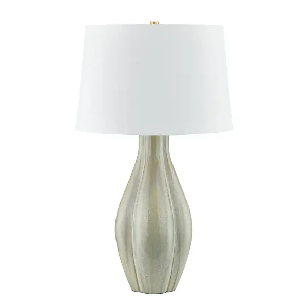 This Hudson Valley table lamp combines a handcrafted ceramic base in coastal green with aged brass accents, creating a sophisticated transitional piece that bridges traditional craftsmanship with contemporary sensibility.