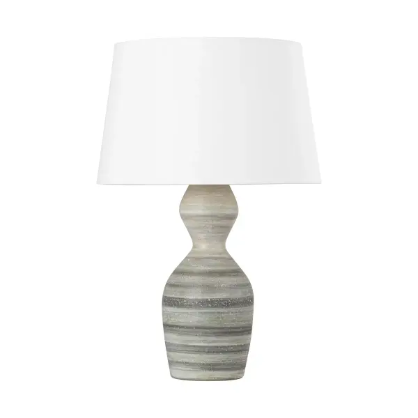 This sophisticated table lamp combines a ceramic white dune base with vintage gold leaf detailing, creating a refined transitional aesthetic. The single-light design offers versatile ambient lighting for residential and hospitality settings.
