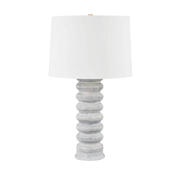 This Hudson Valley table lamp combines artisanal ceramic craftsmanship with warm aged brass detailing. The grey-white ceramic base offers textural interest while maintaining versatility across design schemes.