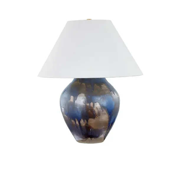 This sophisticated table lamp combines warm aged brass with a distinctive silt blue ceramic element, creating a refined transitional aesthetic. The single-light design offers versatile ambient lighting for residential and hospitality settings.