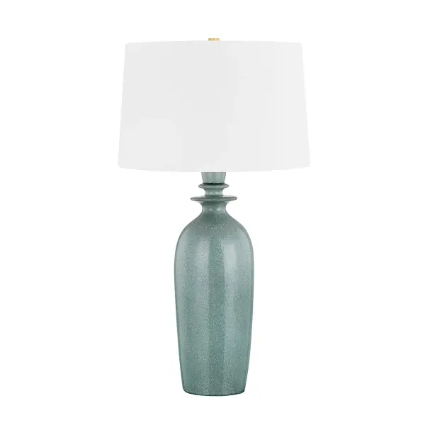 This sophisticated table lamp combines reactive ceramic craftsmanship with aged brass accents, creating a refined transitional piece. The reactive glaze finish ensures each lamp is unique, while the warm brass tones add timeless elegance.
