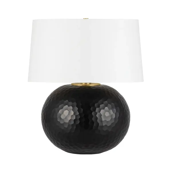 The Dashville combines meticulous hand-cut dark glass with aged brass accents and a natural linen drum shade. Its faceted glass base creates dimensional light play while maintaining petite proportions balanced by the oversized shade.
