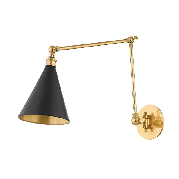 The Osterley wall sconce combines simple cone geometry with sophisticated dual finishes—Aged Brass interior and Distressed Bronze exterior. Its articulating arm makes it exceptionally versatile for bedside reading or accent lighting.