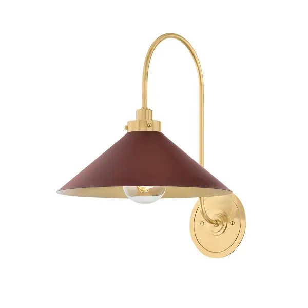 This sophisticated wall sconce combines aged brass metalwork with a distinctive soft crimson glass shade, creating a warm, inviting glow. Perfect for adding character to intimate spaces while providing functional task lighting.
