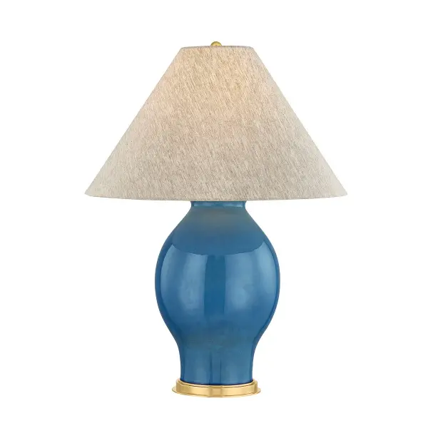 This sophisticated table lamp combines a French blue ceramic base with aged brass hardware for a refined transitional aesthetic. The ceramic construction and quality finish make it a versatile accent piece.