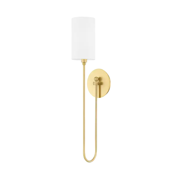 The Harlem Wall Sconce blends vintage-inspired swooping arms with contemporary minimalism. Its linen drum shade softens the elongated frame, creating a sophisticated fixture that works in traditional and modern spaces alike.