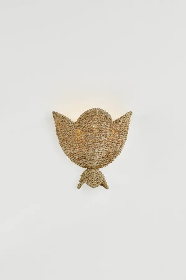 The Solie Wall Sconce brings nature indoors with its distinctive flower-shaped shade handcrafted from twisted palm leaves. Each piece showcases artisan expertise with uniform weaving that creates an upscale, tailored look while maintaining organic charm. - alternate view