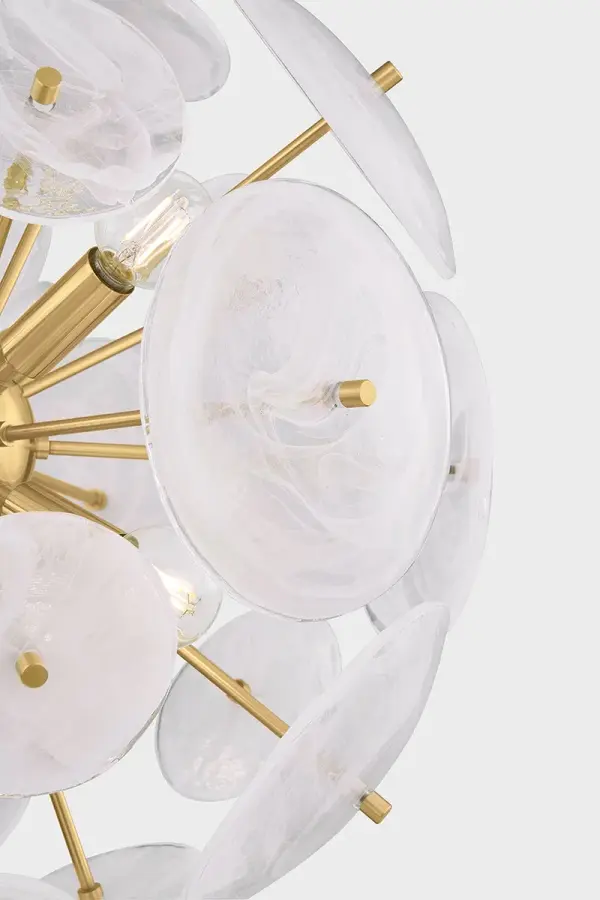 The Tamara chandelier reimagines the classic sputnik design with milky white swirled glass discs and slender aged brass stems. Its harmonious blend of linear and organic forms creates a luminous focal point perfect for modern dining and living spaces. - alternate view