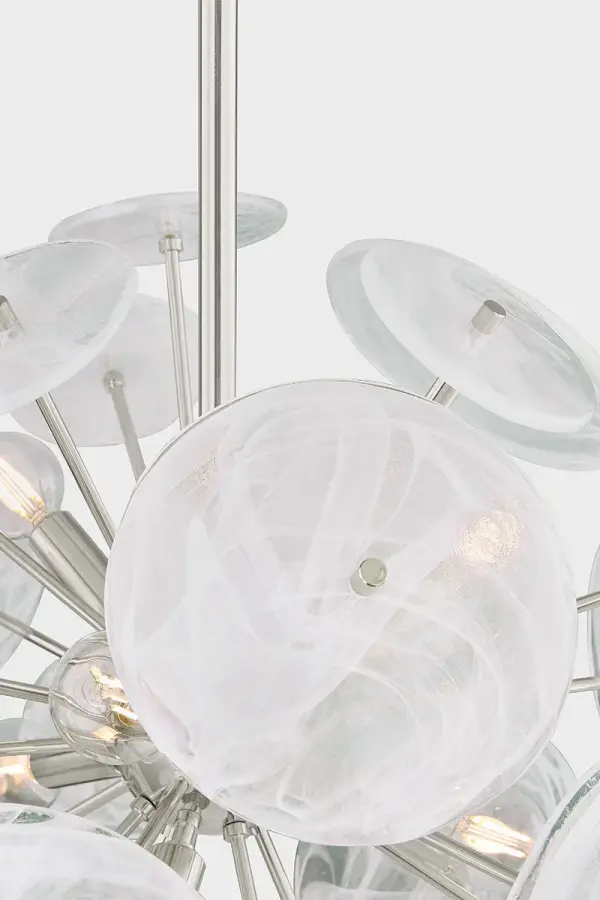 The Tamara chandelier reimagines the classic sputnik silhouette with milky white swirled glass discs and slender Aged Brass stems. Its harmonious blend of linear and organic shapes creates a luminous focal point. - alternate view