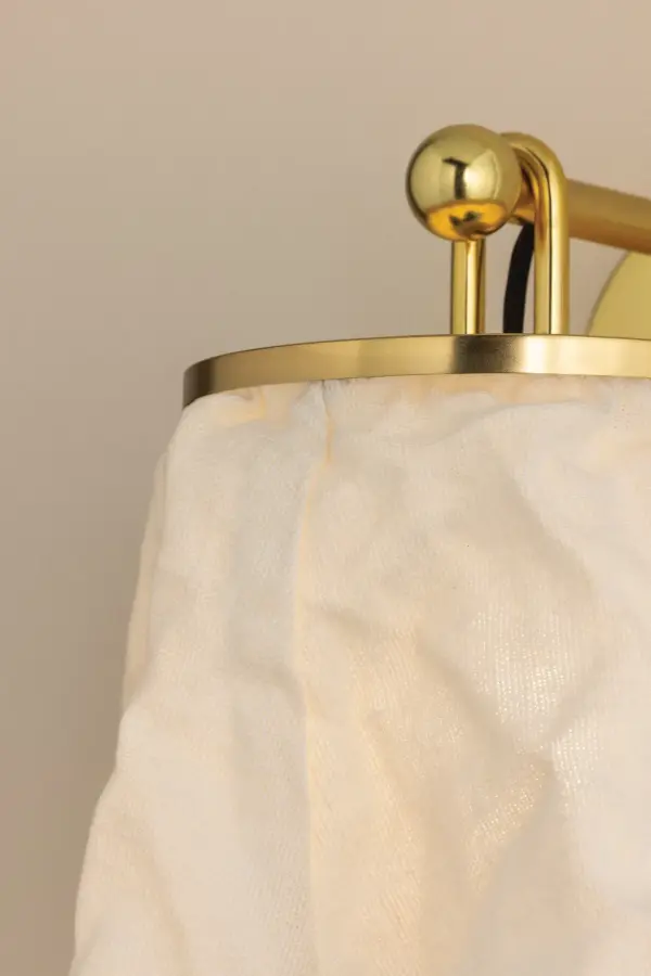 The Jalissa wall sconce blends Art Nouveau design with contemporary sensibility. Its U-shaped loop creates graphic visual interest while the natural linen shade adds warmth and texture, perfectly balancing structured metalwork with relaxed elegance. - alternate view