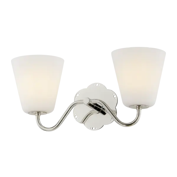 The Leonella sconce brings vintage botanical elegance to bathroom lighting with its floral-shaped backplate and decorative perforations. Swooping arms hold bell-shaped matte white shades that provide powerful downlight for daily routines.
