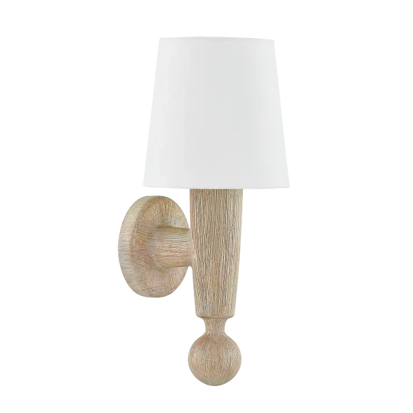 The Nola Wall Sconce brings understated elegance through handcarved cerused whitewash wood and a simple linen shade. Inspired by iconic Scandinavian designers, each piece features unique wood grain patterns for authentic artisanal character. - alternate view
