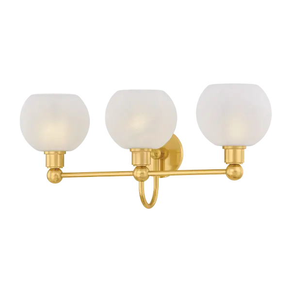 The Jerica bath light brings serene sophistication to bathroom spaces with its harmonious circular forms and decorative sphere details. Matte cloud glass globes provide soft, flattering illumination while the Aged Brass finish adds warmth and elegance.