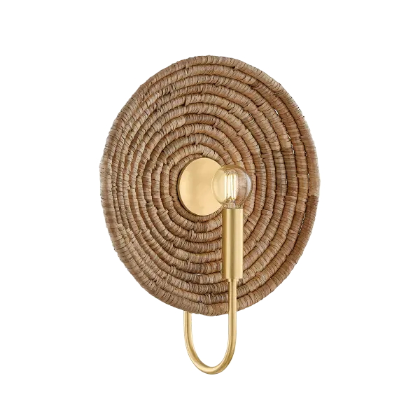 The Ashby Wall Sconce blends global craftsmanship with contemporary style through its distinctive woven basketry backdrop and Aged Brass frame. Each piece showcases unique handcrafted details with a reflector disc for optimal light distribution.