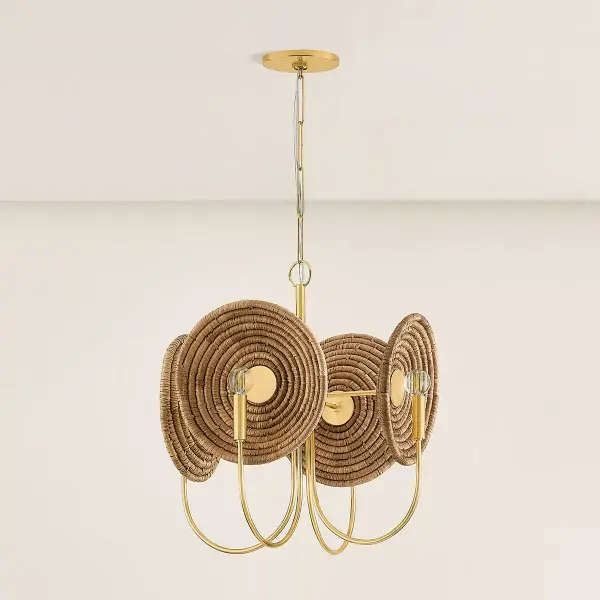 The Ashby Chandelier merges traditional basketry techniques with modern design, featuring handwoven circular motifs that serve as decorative backdrops for four candle-style lights. The Aged Brass frame includes disc reflectors for optimal light distribution. - alternate view